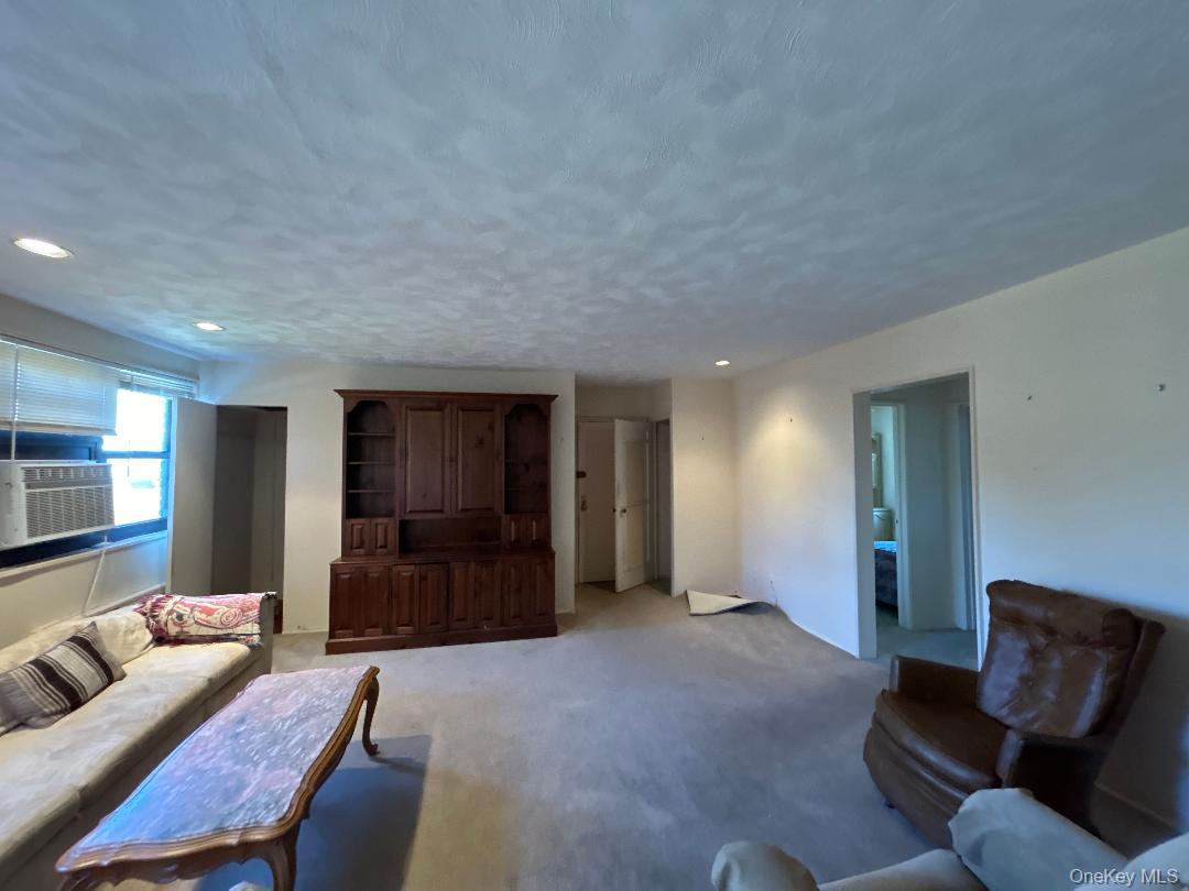 17-15 160th Street, Unit 594 Queens, NY 11357 - Photo 14 of 24 a living room with furniture and a window