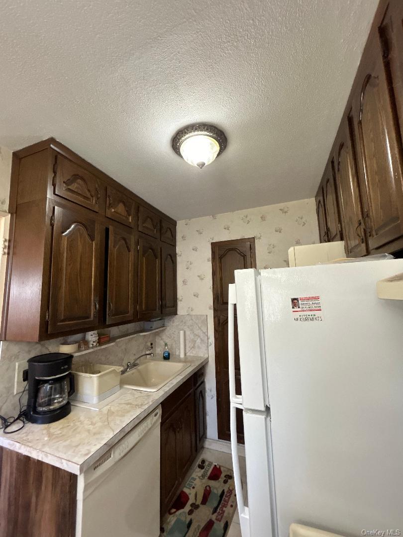 17-15 160th Street, Unit 594 Queens, NY 11357 - Photo 15 of 24 a kitchen with stainless steel appliances a stove refrigerator and a sink