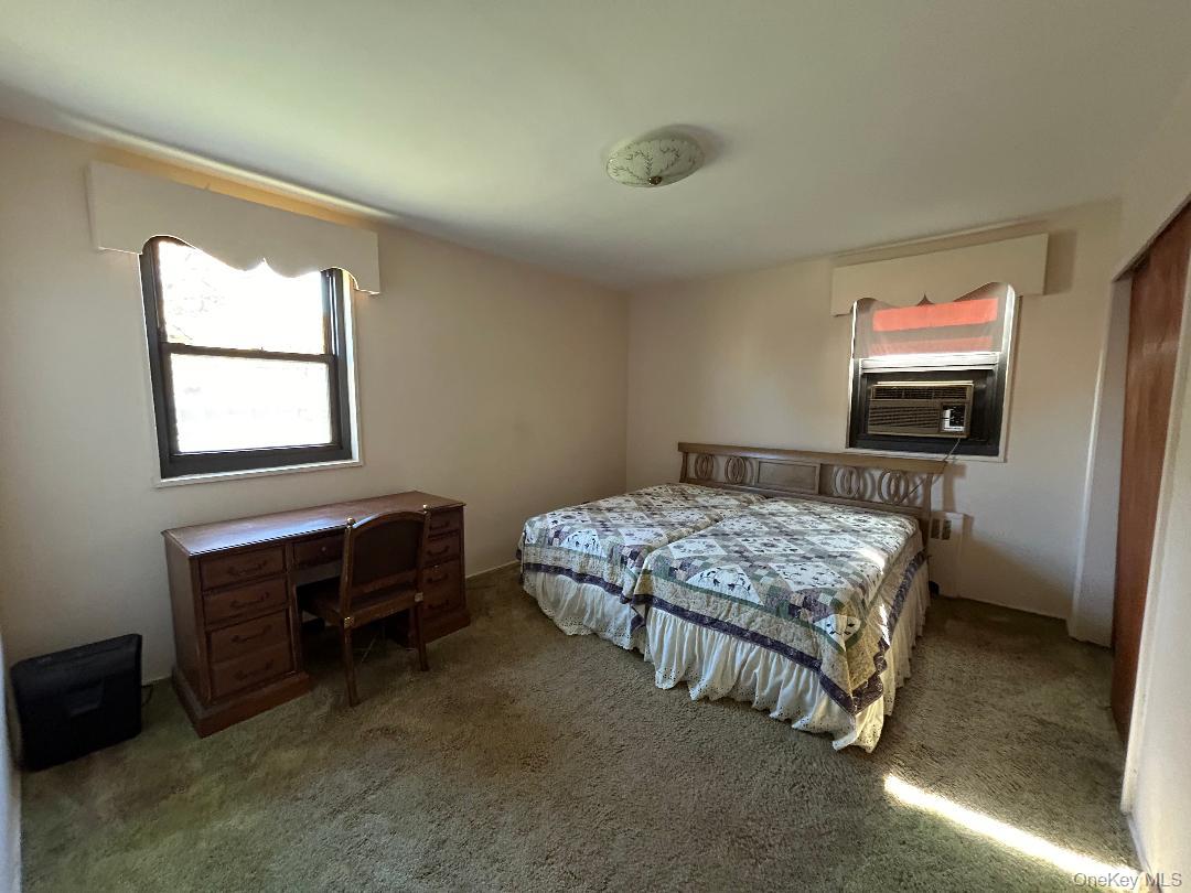 17-15 160th Street, Unit 594 Queens, NY 11357 - Photo 20 of 24 a bedroom with a bed and a tv on table
