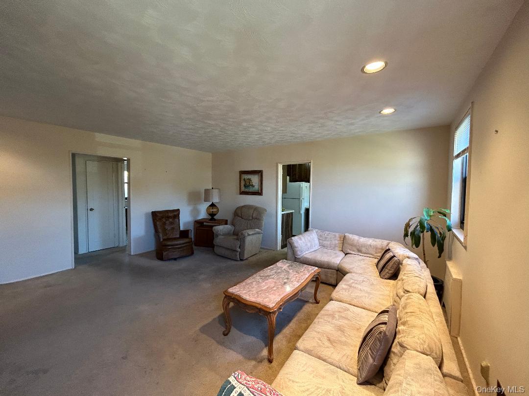 17-15 160th Street, Unit 594 Queens, NY 11357 - Photo 22 of 24 a bedroom with furniture and a chandelier