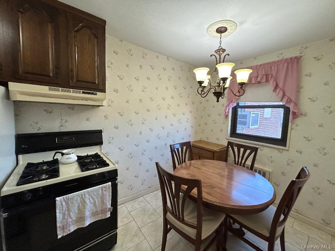 17-15 160th Street, Unit 594 Queens, NY 11357 - Photo 3 of 24 a kitchen with a table and chairs in it