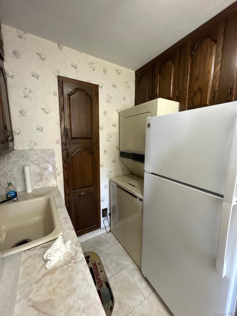 17-15 160th Street, Unit 594 Queens, NY 11357 - Photo 4 of 24 a white refrigerator freezer and a stove sitting inside of a kitchen