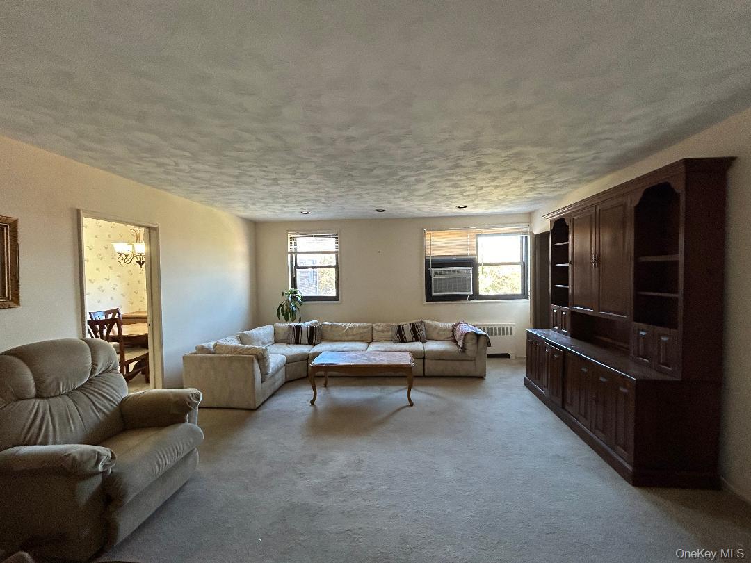 17-15 160th Street, Unit 594 Queens, NY 11357 - Photo 7 of 24 a living room with furniture and a flat screen tv