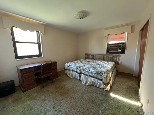 a bedroom with a bed and a television
