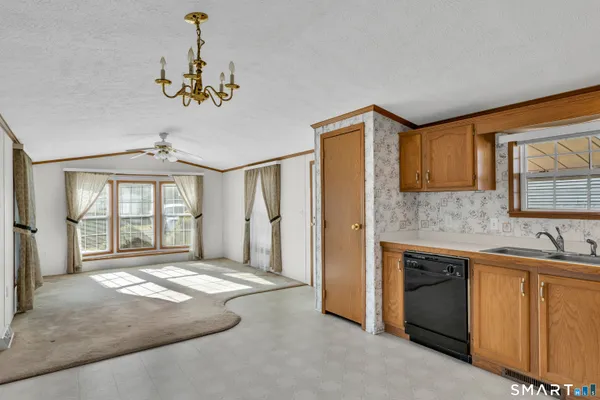 a kitchen with stainless steel appliances granite countertop a refrigerator a oven a sink dishwasher and a stove with a refrigerator
