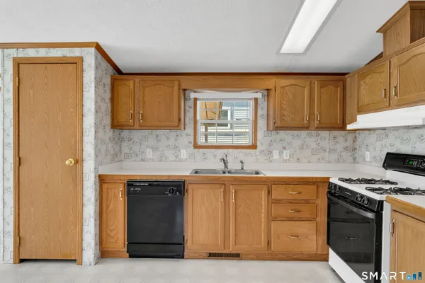 a kitchen with a stove a refrigerator and a sink