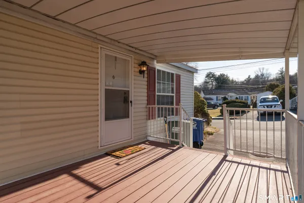a view of a balcony with wooden floor