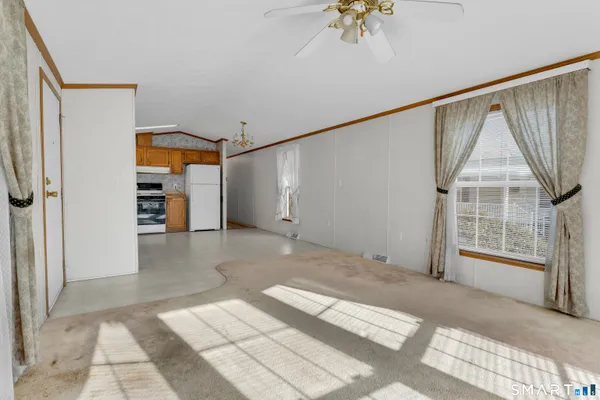 a view of a big room with windows and entryway