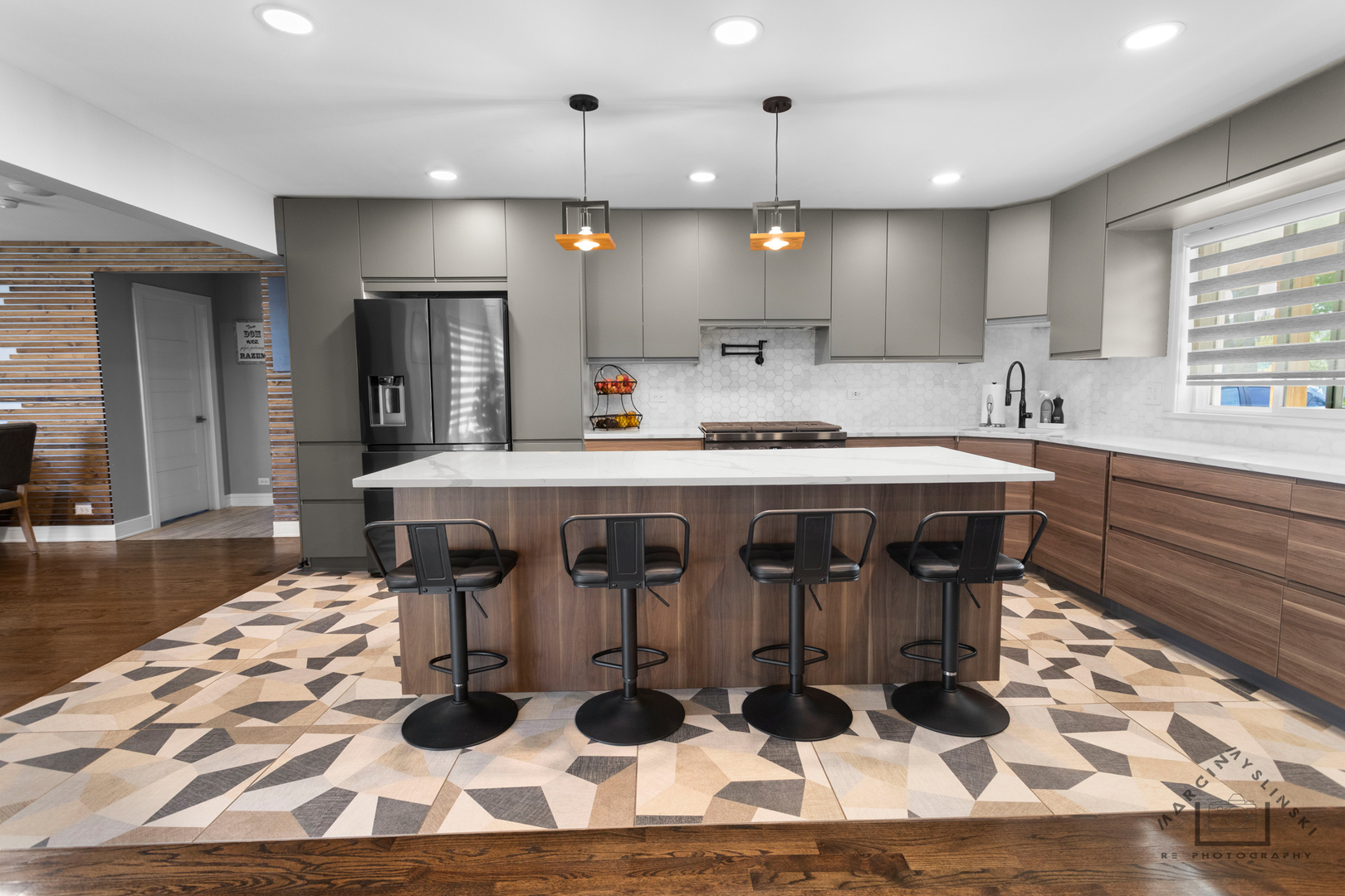 575 Olive Street Hoffman Estates, IL 60169 - Photo 3 of 26 a kitchen with stainless steel appliances kitchen island granite countertop a table and chairs in it