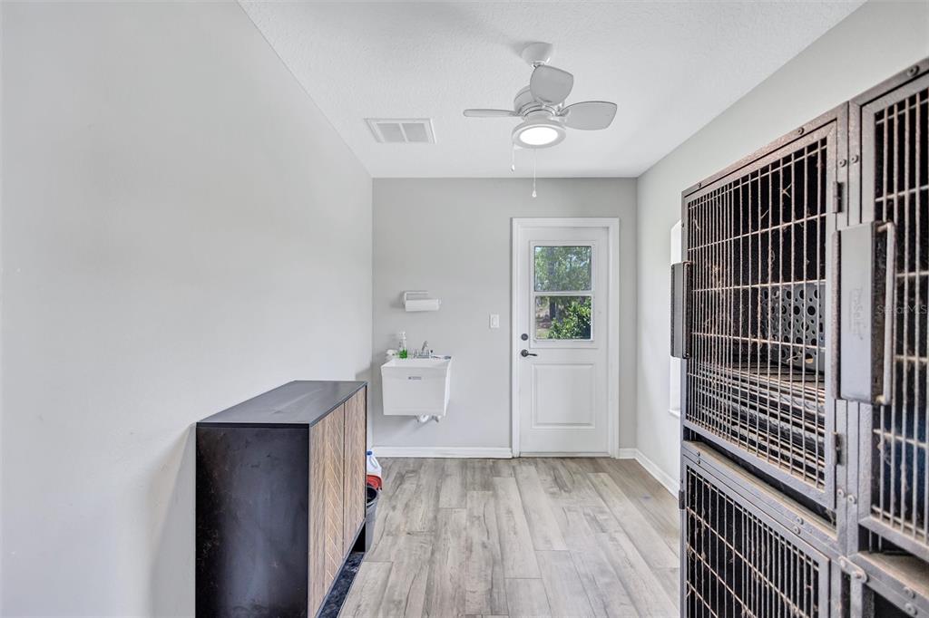 13362 Downy Woodpecker Road Weeki Wachee, FL 34614 - Photo 17 of 26 a view of hallway with wooden floor and chandelier