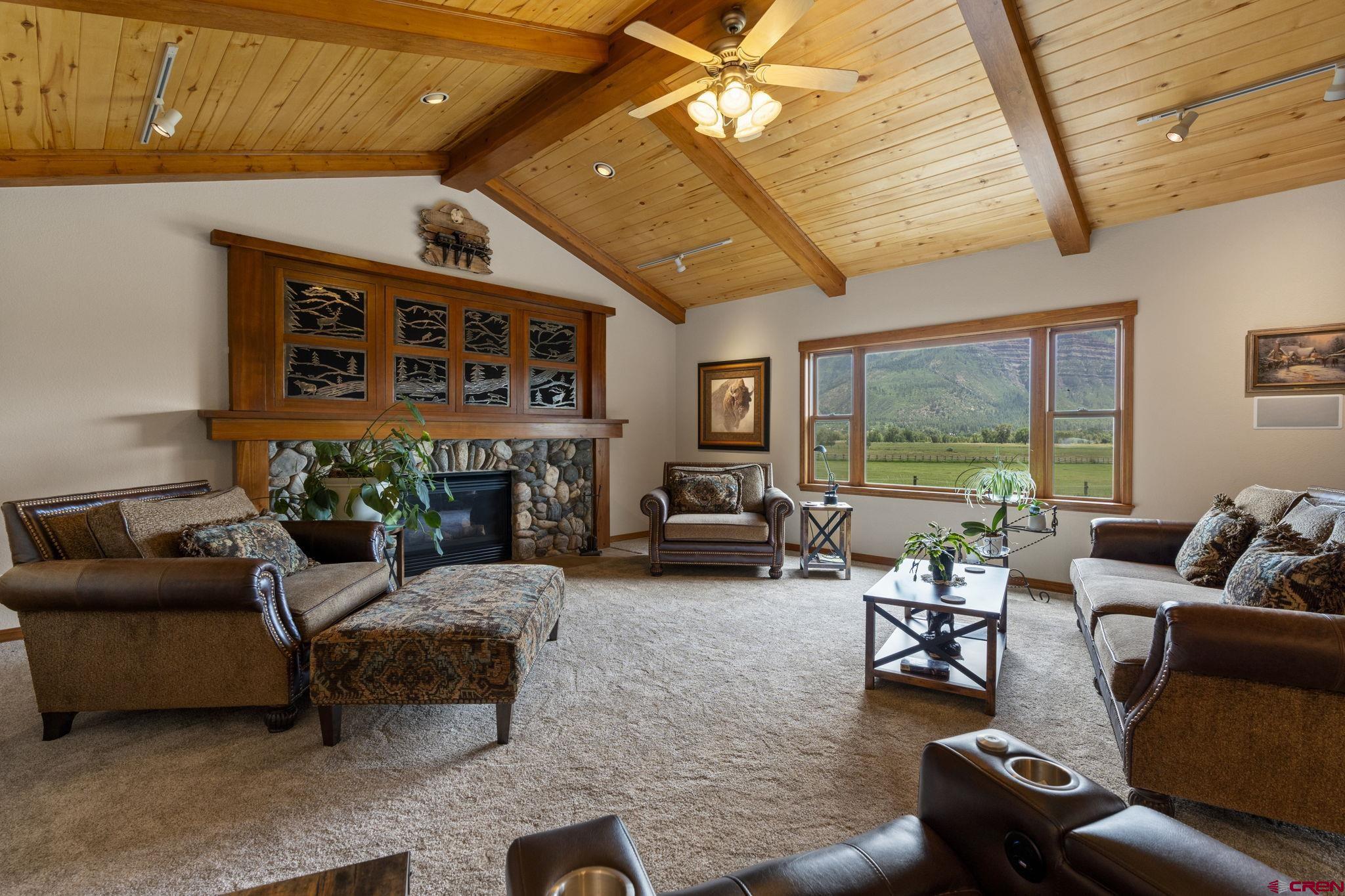 33140 Highway 550 Durango, CO 81301 - Photo 17 of 38 a living room with furniture a fireplace and a table