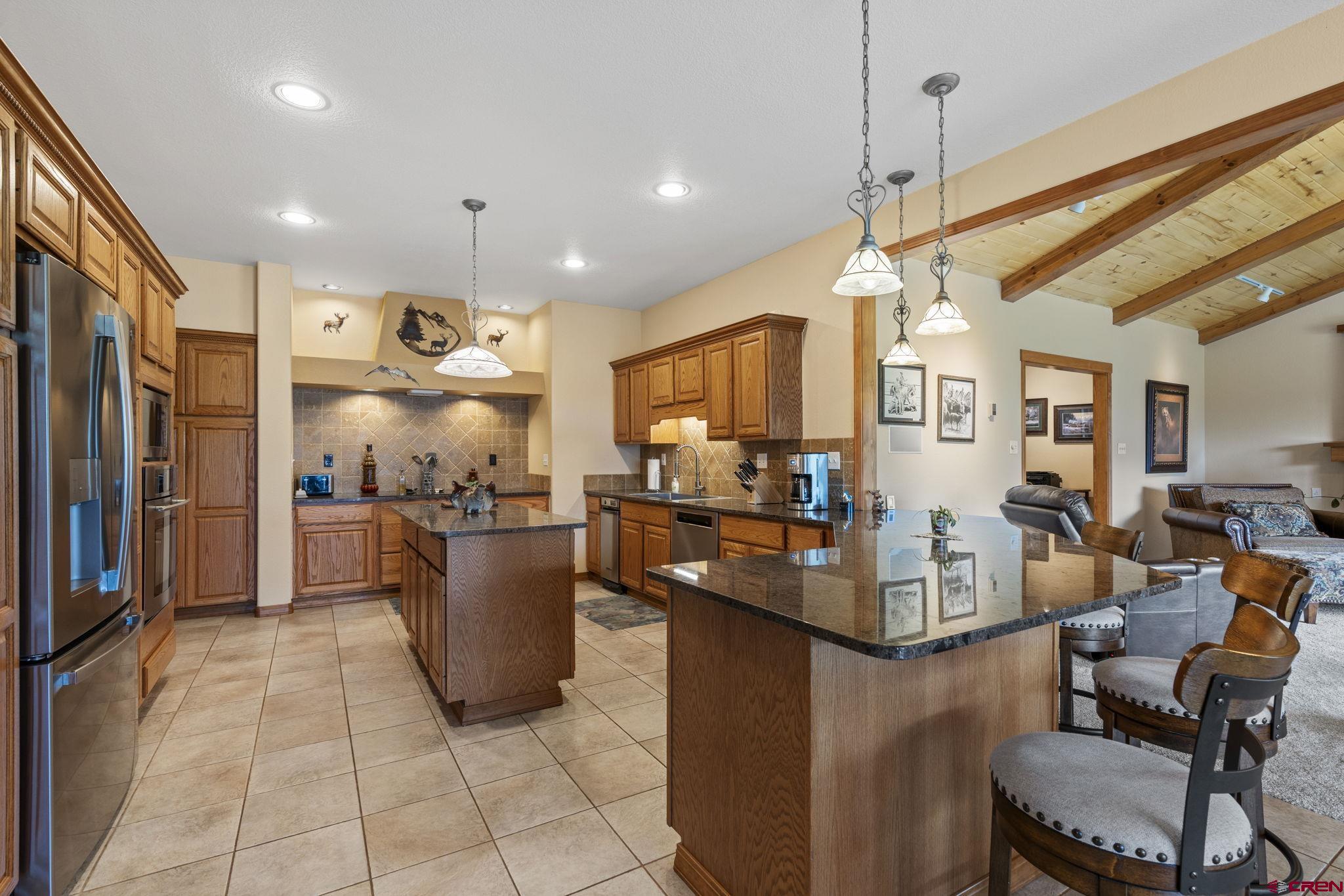 33140 Highway 550 Durango, CO 81301 - Photo 18 of 38 a kitchen with a refrigerator and a view of living room
