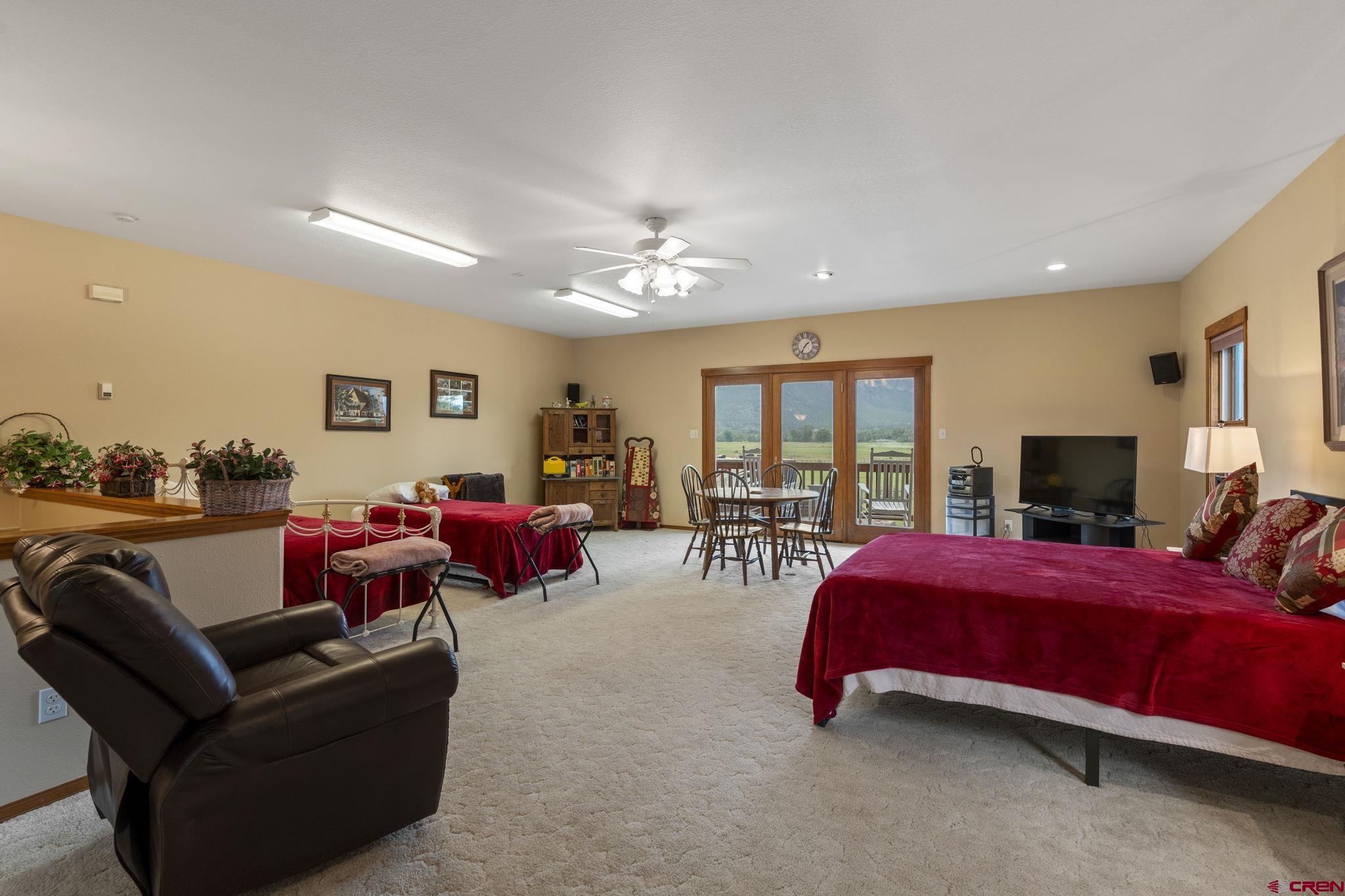 33140 Highway 550 Durango, CO 81301 - Photo 27 of 38 a bedroom with furniture and a flat screen tv