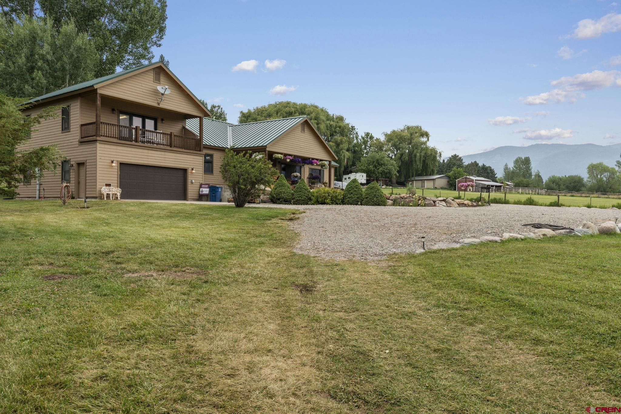 33140 Highway 550 Durango, CO 81301 - Photo 36 of 38 a front view of a house with a yard and garage