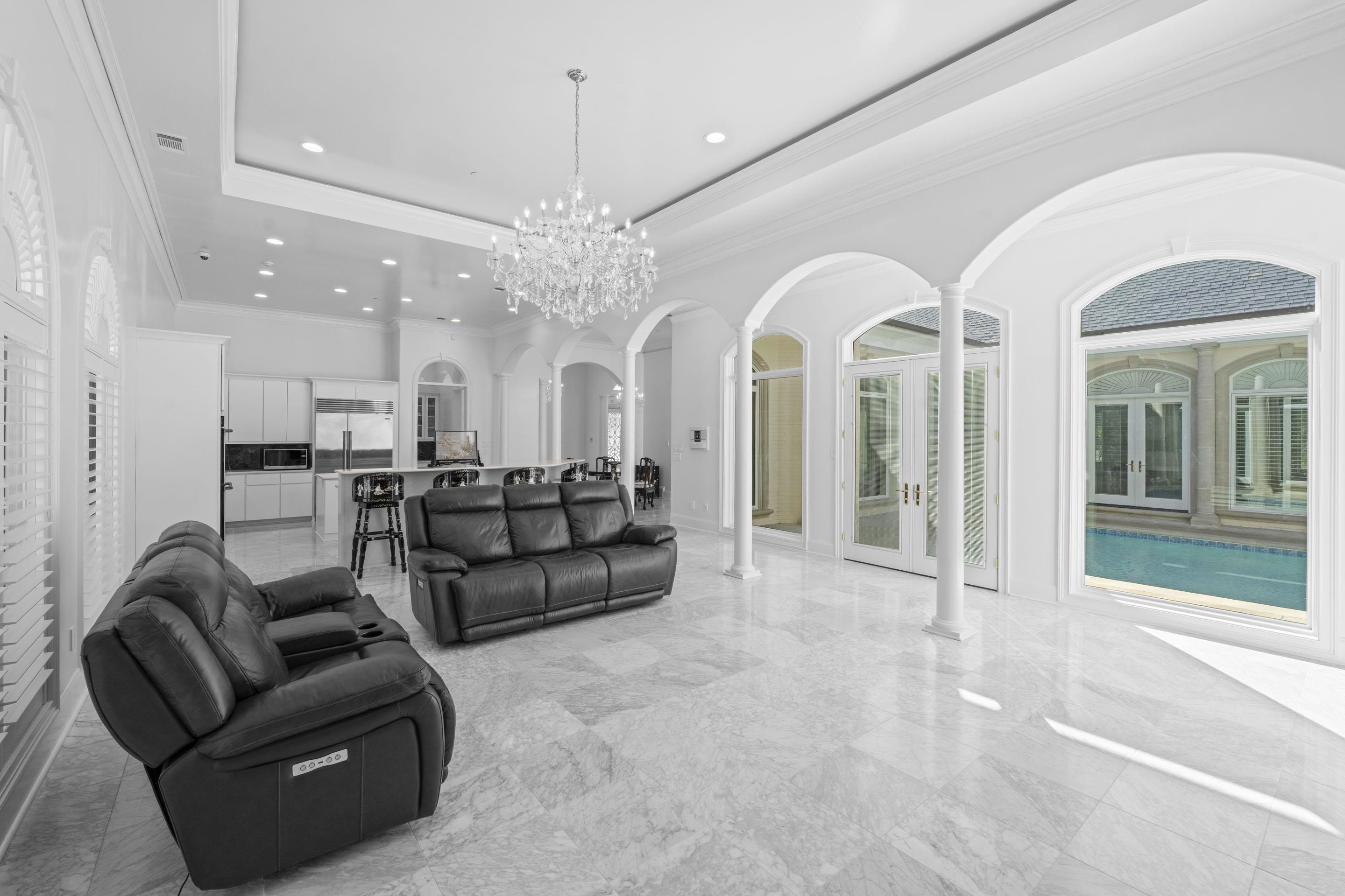 881 Bray Station Road Collierville, TN 38017 - Photo 11 of 40 Living room with a tray ceiling, arched walkways, ornamental molding, a chandelier, and recessed lighting
