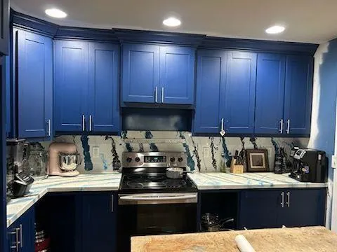 a kitchen with a sink a stove and cabinets
