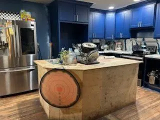 a kitchen with a sink a microwave a refrigerator and cabinets