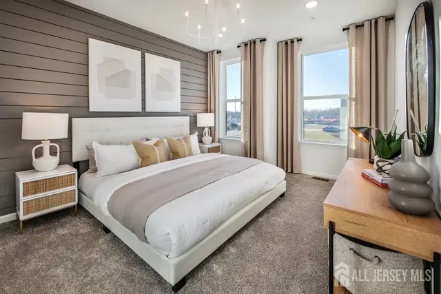 a bedroom with a bed and large window