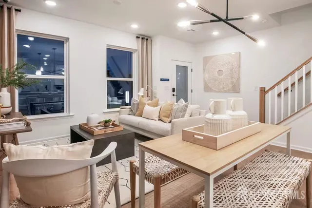 a living room with furniture a window and a table