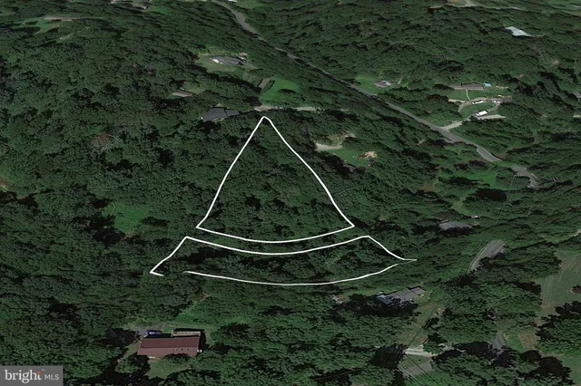 an aerial view of a residential houses with outdoor space