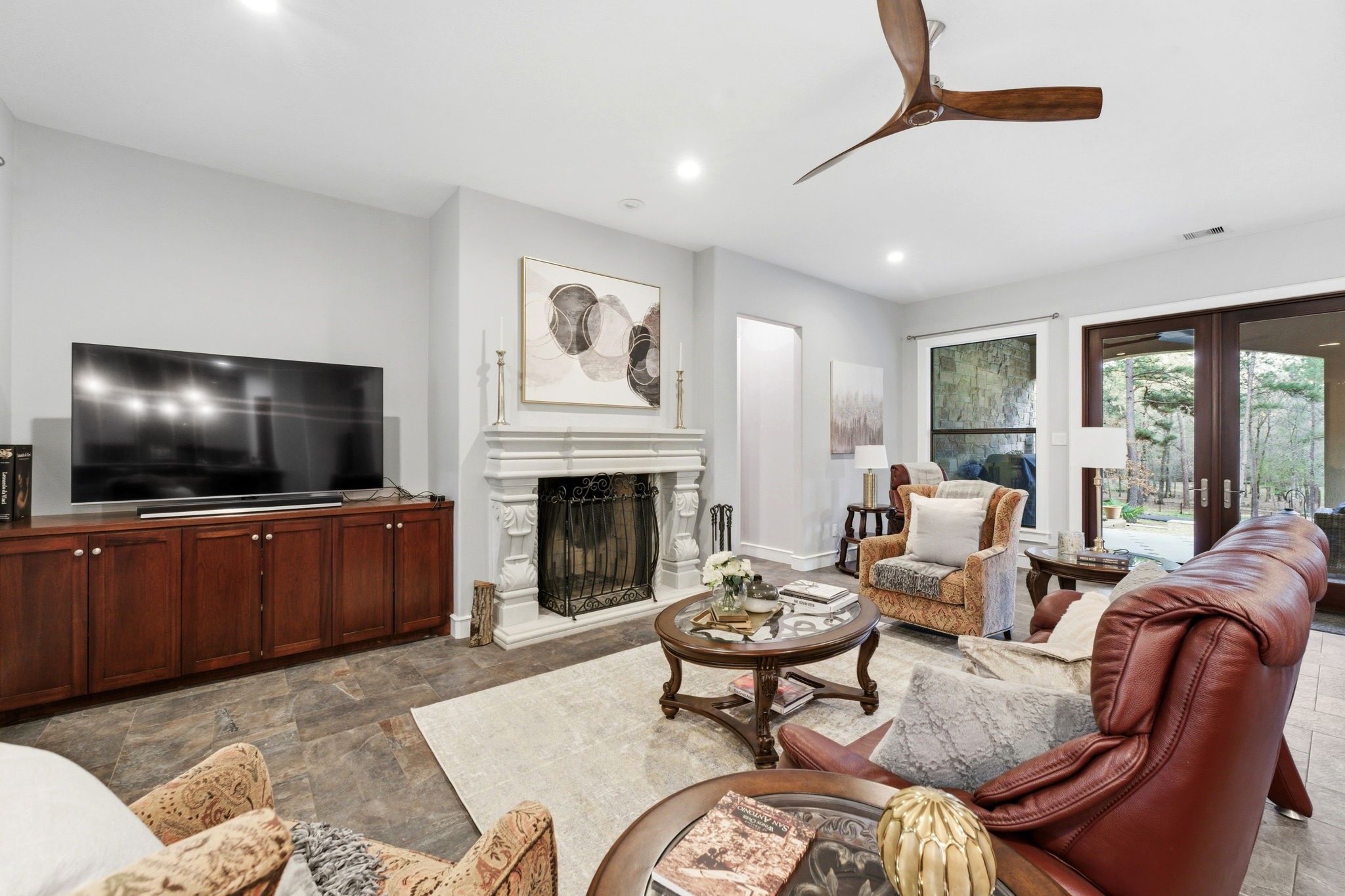 280 Sundog Road Huntsville, TX 77340 - Photo 11 of 50 a living room with furniture a flat screen tv and a fireplace