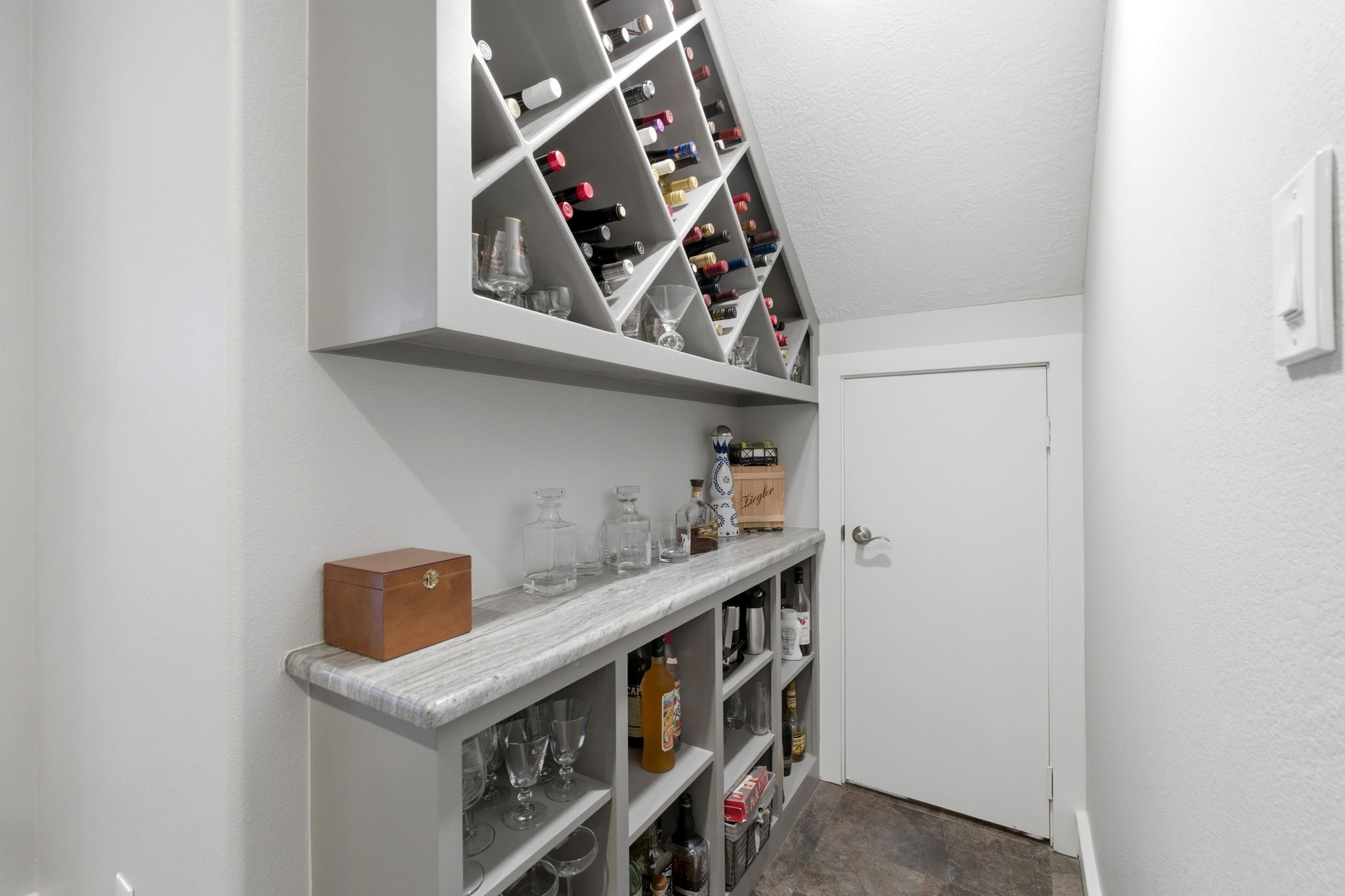 280 Sundog Road Huntsville, TX 77340 - Photo 19 of 50 Built-in wine storage area with display racks and cabinetry below, creating a stylish and functional feature near the main living spaces.
