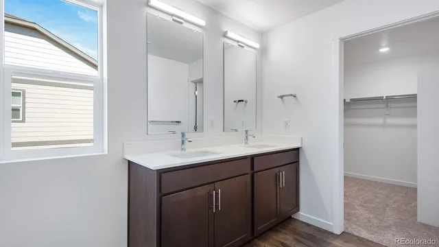 a bathroom with a sink double vanity and a mirror