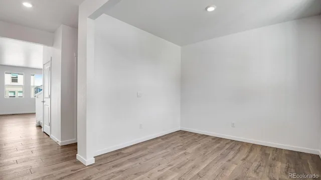 a view of a room with wooden floor