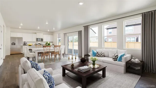 a living room with furniture and kitchen view
