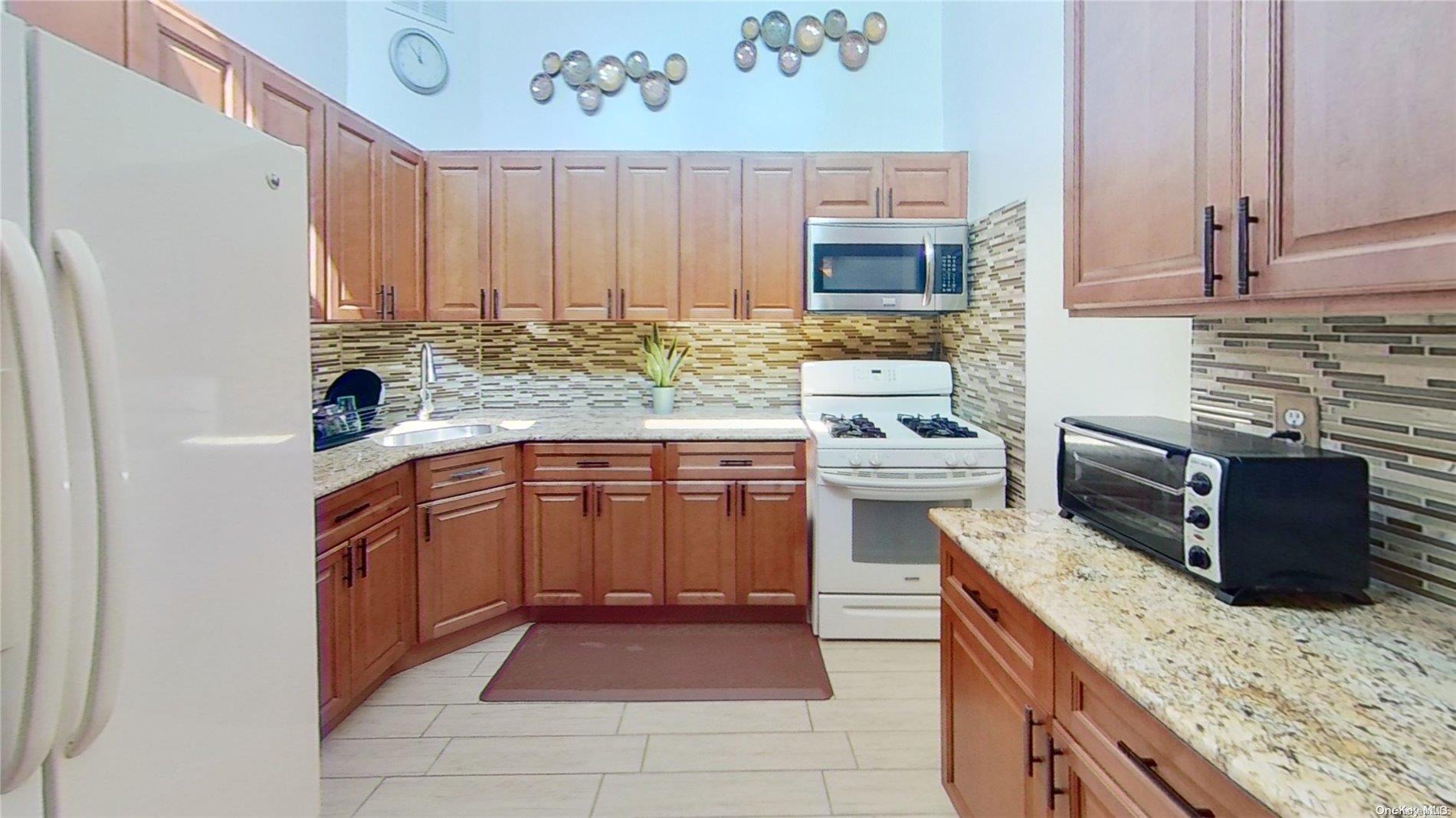 610 Pine Street Brooklyn, NY 11208 - Photo 11 of 35 a kitchen with stainless steel appliances granite countertop a stove a sink dishwasher and a refrigerator