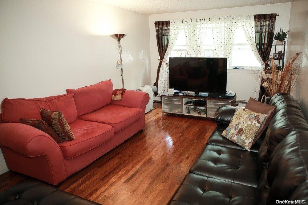 610 Pine Street Brooklyn, NY 11208 - Photo 12 of 35 a living room with furniture and a flat screen tv