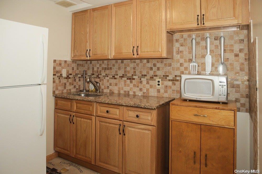 610 Pine Street Brooklyn, NY 11208 - Photo 13 of 35 a bathroom with a sink and cabinets