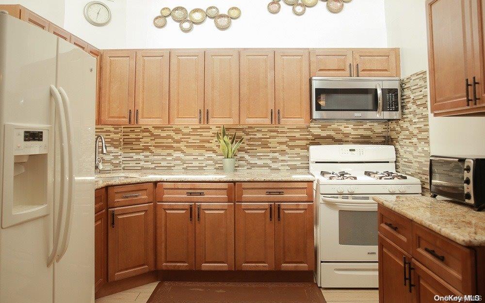 610 Pine Street Brooklyn, NY 11208 - Photo 15 of 35 a kitchen with stainless steel appliances granite countertop a stove a sink and a refrigerator