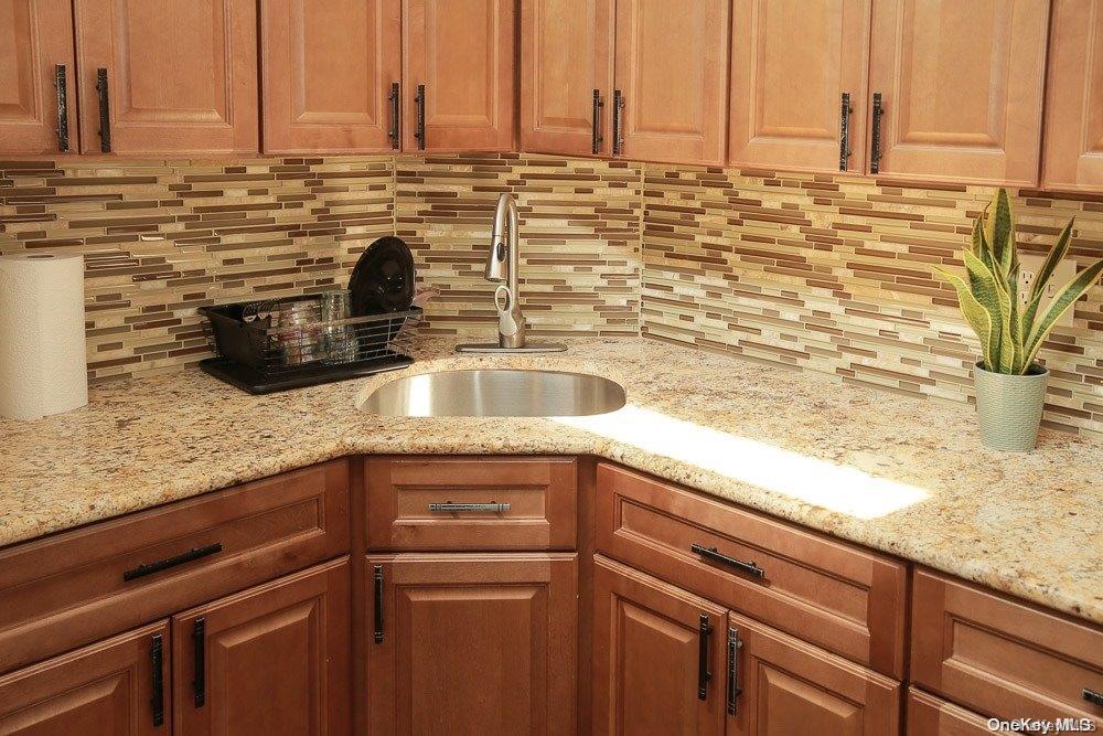 610 Pine Street Brooklyn, NY 11208 - Photo 16 of 35 a kitchen with a sink and a wooden floor