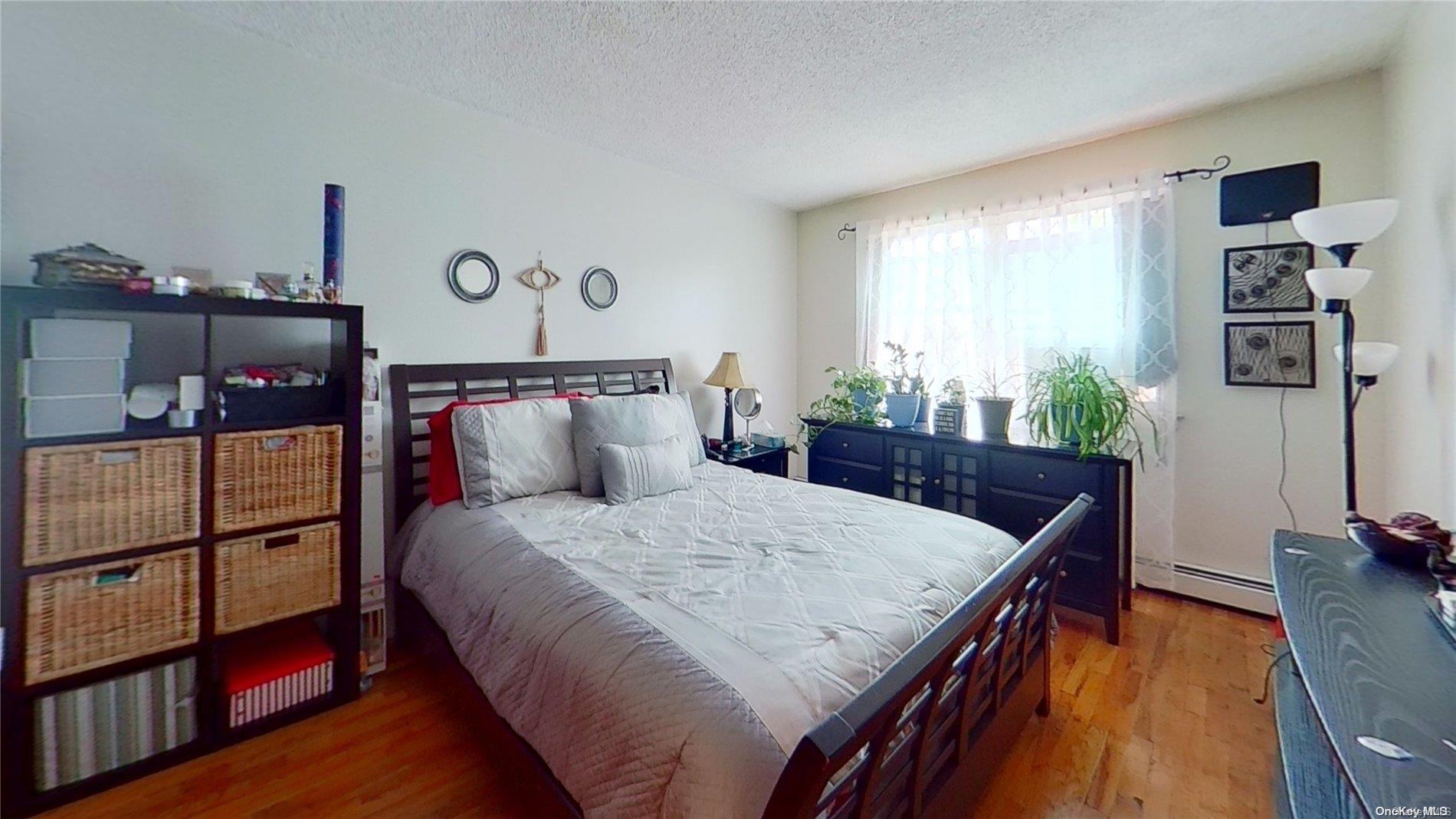 610 Pine Street Brooklyn, NY 11208 - Photo 20 of 35 a bedroom with a bed and wooden floor