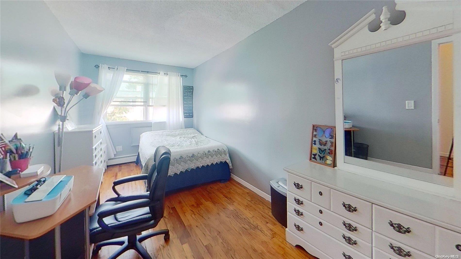 610 Pine Street Brooklyn, NY 11208 - Photo 22 of 35 a bedroom with a bed and a dresser in it