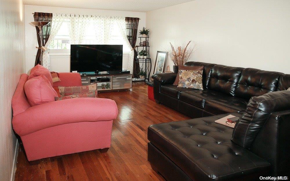610 Pine Street Brooklyn, NY 11208 - Photo 33 of 35 a living room with furniture and a flat screen tv
