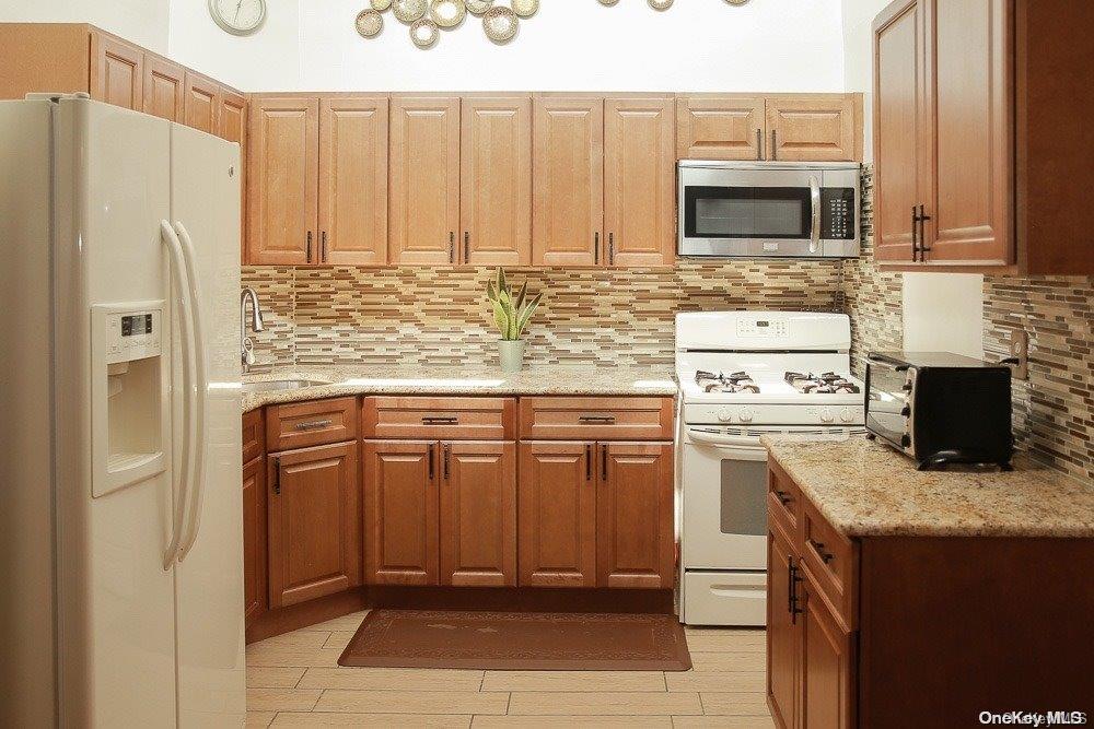 610 Pine Street Brooklyn, NY 11208 - Photo 4 of 35 a kitchen with stainless steel appliances granite countertop a refrigerator stove and microwave