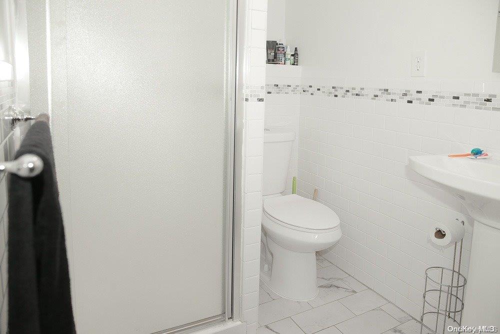 610 Pine Street Brooklyn, NY 11208 - Photo 5 of 35 a bathroom with a toilet and a sink