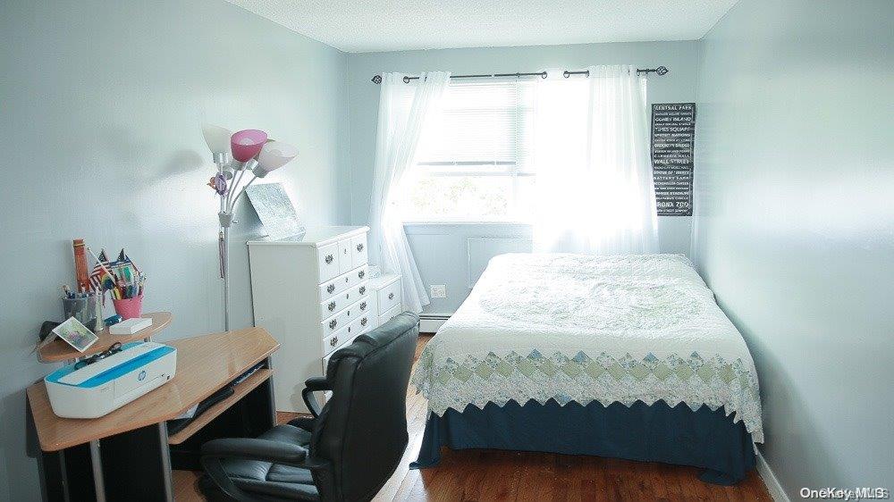 610 Pine Street Brooklyn, NY 11208 - Photo 7 of 35 a bedroom with a bed table and a window