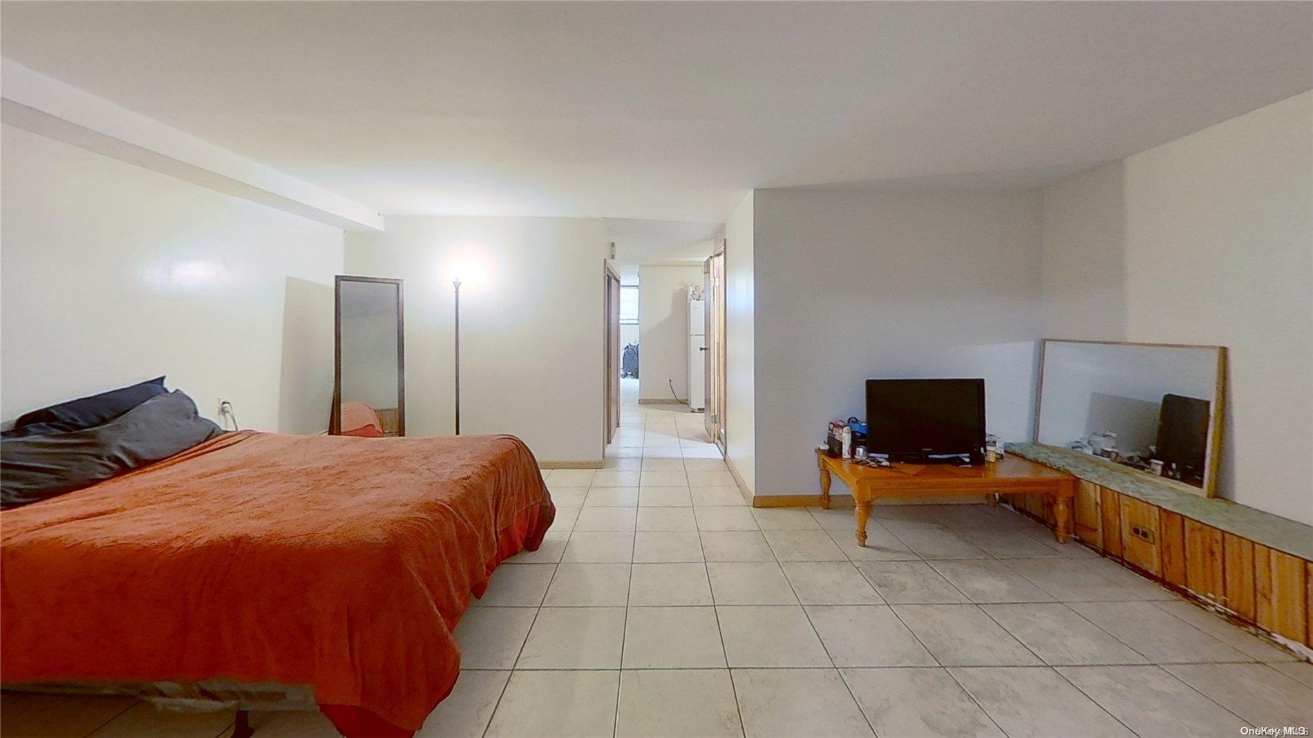 610 Pine Street Brooklyn, NY 11208 - Photo 9 of 35 a bedroom with a bed and a flat screen tv