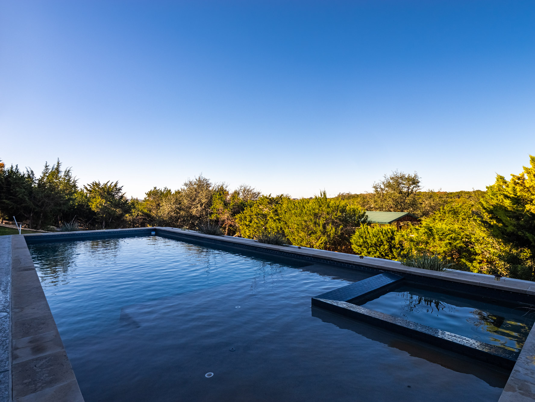 14900 Copper Ridge Lane Austin, TX 78734 - Photo 30 of 39 View of swimming pool featuring a pool with connected hot tub