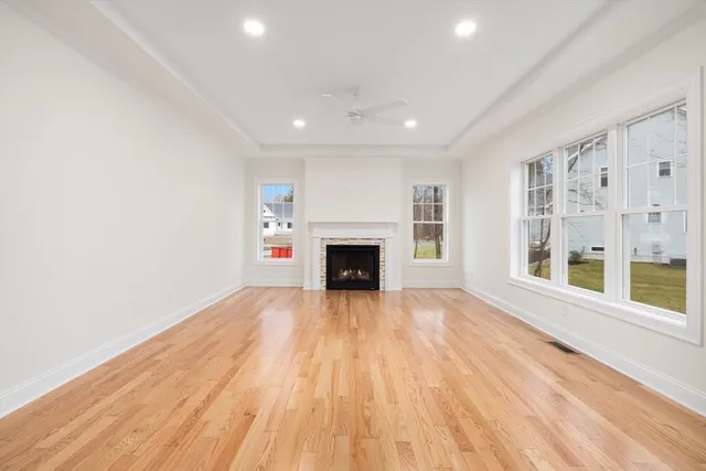 wooden floor in an empty room with a fireplace