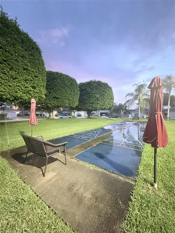 a swimming pool with outdoor seating and yard