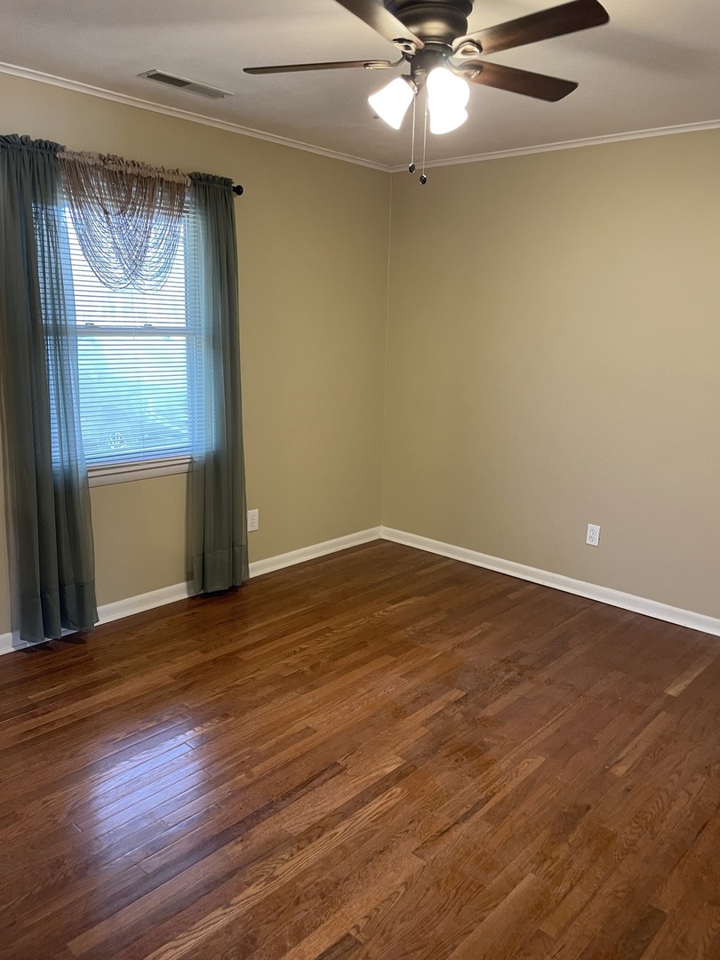3512 Riverview Lake Road Metropolis, IL 62960 - Photo 11 of 20 an empty room with wooden floor fan and windows