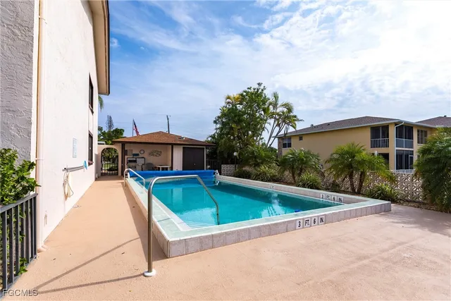 a view of a house with pool and sitting area