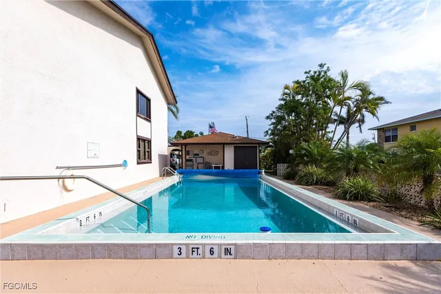 a view of swimming pool with outdoor seating and yard in back