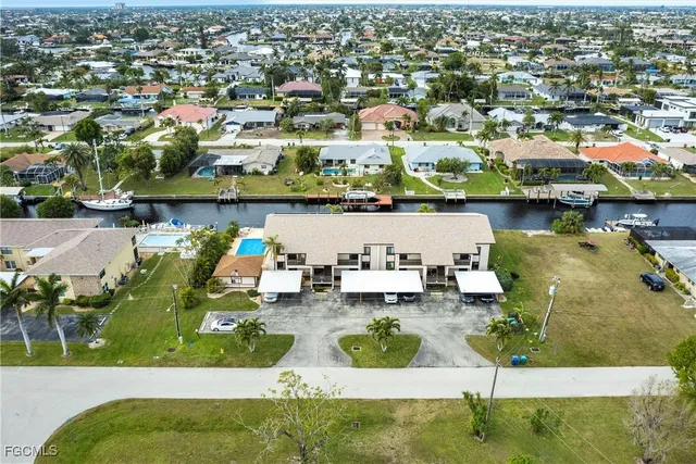 an aerial view of multiple houses with swimming pool