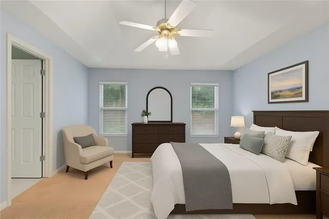 a bedroom with a bed couch and a window