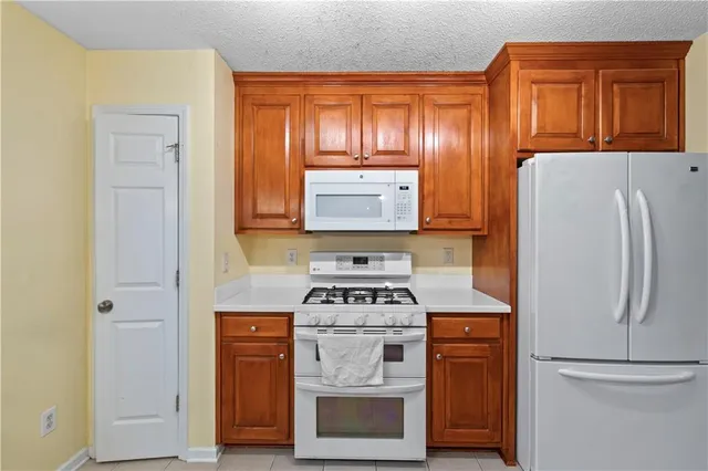 a kitchen with a stove and a refrigerator
